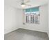 Bright bedroom with tile flooring and large window offering city views at 322 E Central Blvd # 1711, Orlando, FL 32801