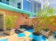 Relaxing pool area with a tiled patio and lush landscaping at 322 E Central Blvd # 1711, Orlando, FL 32801