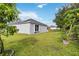 Landscaped backyard with grassy area and trees at 805 Nelson Dr, Kissimmee, FL 34758