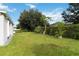 Spacious backyard with lush lawn and greenery at 805 Nelson Dr, Kissimmee, FL 34758