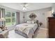 Cozy bedroom with a large bed and window at 805 Nelson Dr, Kissimmee, FL 34758