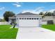 Newly renovated one-story home with a two-car garage and manicured lawn at 805 Nelson Dr, Kissimmee, FL 34758