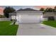 House exterior view at dusk showing a white two-car garage at 805 Nelson Dr, Kissimmee, FL 34758