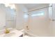 Bathroom with white subway tile, a bathtub, and white countertop with gold hardware at 9982 Fiddley Aly, Orlando, FL 32827