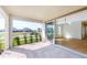 Covered lanai with stone tile and a sliding glass door leading inside the home at 9982 Fiddley Aly, Orlando, FL 32827