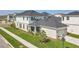 Aerial view of a two-story home with an attached garage and well-maintained lawn in a suburban neighborhood at 9982 Fiddley Aly, Orlando, FL 32827