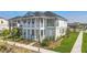 Charming two-story home featuring a covered porch, balcony, and beautifully landscaped front yard at 9982 Fiddley Aly, Orlando, FL 32827