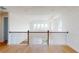 Hallway with hardwood floors and a black metal railing at 9982 Fiddley Aly, Orlando, FL 32827