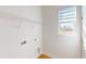 Bright laundry room with a window, shelving, and hookups for a washer and dryer at 9982 Fiddley Aly, Orlando, FL 32827