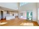 Bright, open-concept living room adjoining a modern kitchen with stainless steel appliances and a sliding glass door at 9982 Fiddley Aly, Orlando, FL 32827