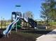 Community playground with a modern play structure featuring slides and climbing areas, set on a soft surface at 9982 Fiddley Aly, Orlando, FL 32827