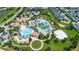 Aerial view of a resort-style community pool with cabanas, palm trees, and lounge chairs at 1427 Rolling Fairway Dr, Davenport, FL 33896