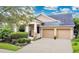 Charming single-Gathering home featuring a two-car garage, manicured landscaping, and a welcoming front porch at 4409 Cleary Way, Orlando, FL 32828