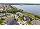 Aerial view of a lakeside community, highlighting waterfront homes, manicured lawns, and mature trees at 16695 Broadwater Ave, Winter Garden, FL 34787