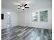 Bright bedroom with wood-look floors, a ceiling fan, and natural light from two large windows at 16695 Broadwater Ave, Winter Garden, FL 34787