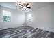 A light-filled bedroom features neutral walls, modern ceiling fan, and gray wood-look flooring at 16695 Broadwater Ave, Winter Garden, FL 34787