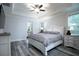 Cozy bedroom features a king-size bed, tray ceiling and bedside tables at 16695 Broadwater Ave, Winter Garden, FL 34787