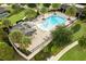 Aerial view of the community pool with palm trees, lounge chairs, and manicured landscaping at 16695 Broadwater Ave, Winter Garden, FL 34787