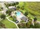 Aerial view of the community pool showcasing palm trees, lounge chairs, and meticulously landscaped areas at 16695 Broadwater Ave, Winter Garden, FL 34787