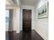 Inviting entryway features a dark wood door, hardwood floors, and wainscoting at 16695 Broadwater Ave, Winter Garden, FL 34787