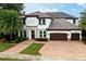 Stunning two-story home with a tile roof, brick driveway, and a beautifully landscaped front yard at 16695 Broadwater Ave, Winter Garden, FL 34787