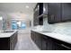 Well-lit kitchen showcases dark cabinets, a long counter and stainless steel appliances at 16695 Broadwater Ave, Winter Garden, FL 34787