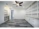 Spacious living room with a large window, built-in shelving and cabinets, modern lighting, and sleek flooring at 16695 Broadwater Ave, Winter Garden, FL 34787