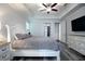 Bright main bedroom features a tray ceiling, ceiling fan, and luxury vinyl flooring at 16695 Broadwater Ave, Winter Garden, FL 34787