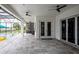 Elegant outdoor living space featuring tile flooring, a modern kitchen, and ceiling fans at 16695 Broadwater Ave, Winter Garden, FL 34787