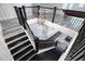 Elegant staircase with dark wood steps, iron railings, and a modern chandelier at 16695 Broadwater Ave, Winter Garden, FL 34787