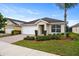 One-story house with a white garage door and neatly landscaped front yard at 258 Vizcay Way, Davenport, FL 33837