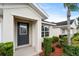 Gray front door with glass panels, and neatly landscaped entryway at 258 Vizcay Way, Davenport, FL 33837