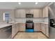 Modern kitchen with light cabinets and tile flooring at 258 Vizcay Way, Davenport, FL 33837