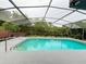 Beautiful screened-in pool surrounded by a deck and lush landscaping at 260 S Fairbairn Dr, Deltona, FL 32725