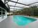 Inviting screened-in pool surrounded by a patio and peaceful backyard greenery at 260 S Fairbairn Dr, Deltona, FL 32725