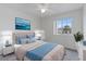 Bright bedroom featuring neutral walls, a window, and a stylish bed with blue accents at 2691 Hawthorne Ln, Kissimmee, FL 34743