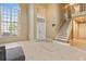 Welcoming foyer with tiled floors, a staircase, and a large window for ample natural light at 2691 Hawthorne Ln, Kissimmee, FL 34743