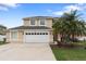 Charming two-story home with a two-car garage and a well-manicured lawn at 2691 Hawthorne Ln, Kissimmee, FL 34743