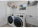 Functional laundry room includes a washer, dryer, utility sink, and storage shelves at 2691 Hawthorne Ln, Kissimmee, FL 34743