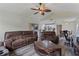 Spacious living room featuring wood flooring, a ceiling fan, and an open layout to the kitchen at 2691 Hawthorne Ln, Kissimmee, FL 34743