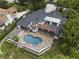 Aerial view showcasing a luxury home with a stunning pool, patio, and manicured landscaping at 904 Main St, Windermere, FL 34786