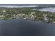 Waterfront property featuring a large home with private docks and lake access, surrounded by lush greenery at 904 Main St, Windermere, FL 34786