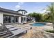 Enjoy the outdoors in this pool area with stone patio, lounge chairs, and tropical landscaping at 904 Main St, Windermere, FL 34786