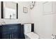 A clean bathroom featuring a white vanity sink and toilet, complemented by a white tiled wall and minimalist design at 904 Main St, Windermere, FL 34786