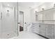 Bathroom with glass shower and gray vanity with double sinks at 904 Main St, Windermere, FL 34786