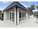 View of boat house with white siding and dark trim, and multiple sliding doors at 904 Main St, Windermere, FL 34786