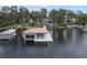 Floating boat house with covered slip, wood roof, and surrounding calm lake waters at 904 Main St, Windermere, FL 34786