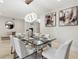 Dining room with modern chandelier, neutral paint and decor and seating for six at 904 Main St, Windermere, FL 34786