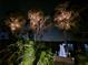 Night view of the lake showcasing a beautifully lit dock, enhancing the waterfront ambiance and charm at 904 Main St, Windermere, FL 34786