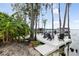 Relaxing dockside retreat with comfortable lounge chairs, offering serene waterfront views amidst lush greenery at 904 Main St, Windermere, FL 34786